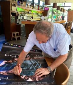 François Mottier am Signieren der Filmplakate.